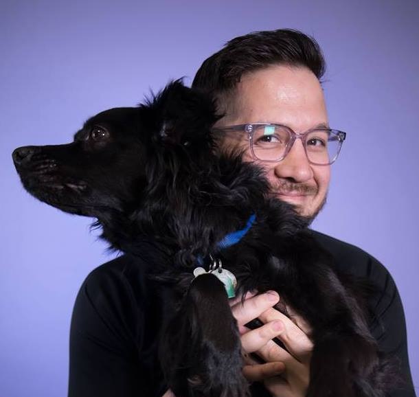 Nick Pappas holding a black dog