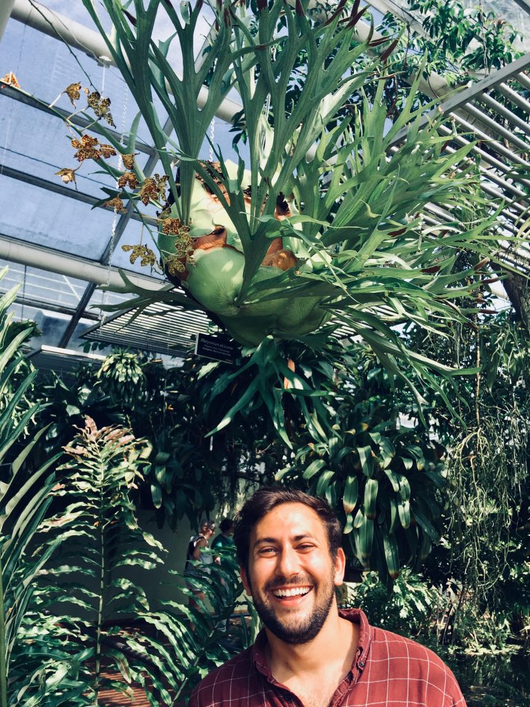 Ari Miller in front of plants