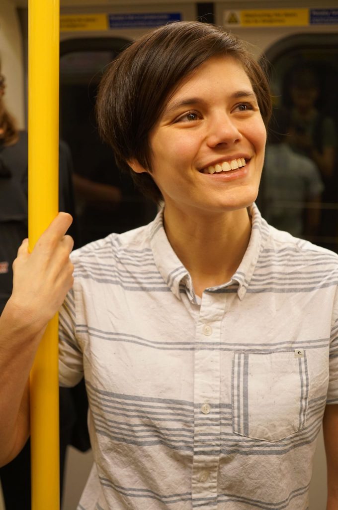 Eleanor Lewis gripping a subway pole.